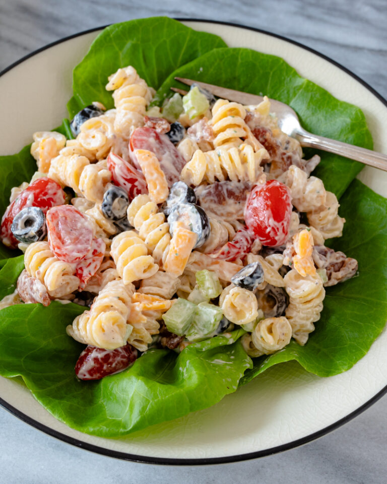 Ranch pasta salad served on a plate with lettuce leaves