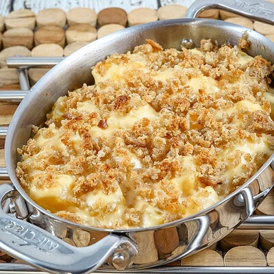A baking dish with rutabaga gratin with breadcrumb topping and cheese.