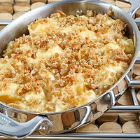 A baking dish with rutabaga gratin with breadcrumb topping and cheese.