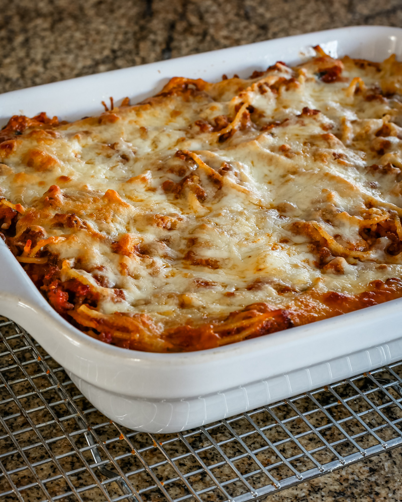 A baked spaghetti casserole on a cooling rack