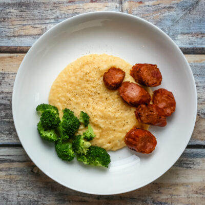 Polenta with spicy andouille sausage on a plate