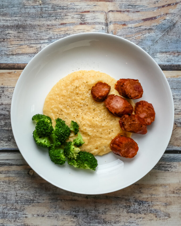 Polenta with spicy andouille sausage on a plate