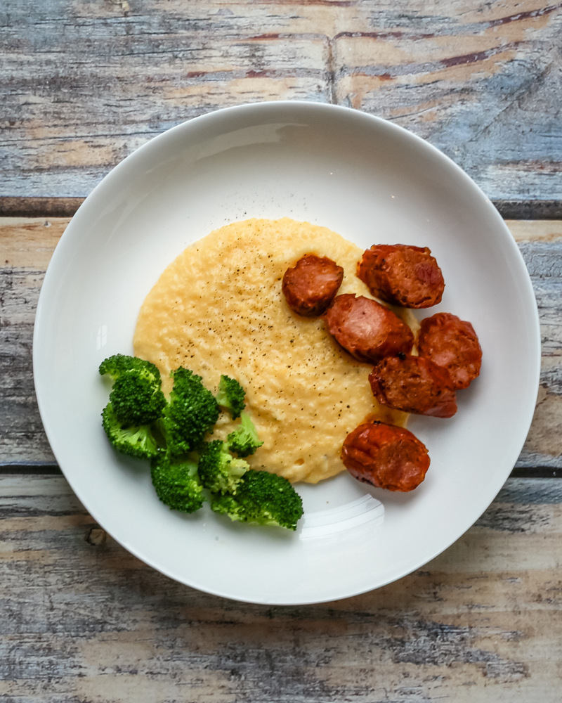 Polenta with spicy andouille sausage on a plate