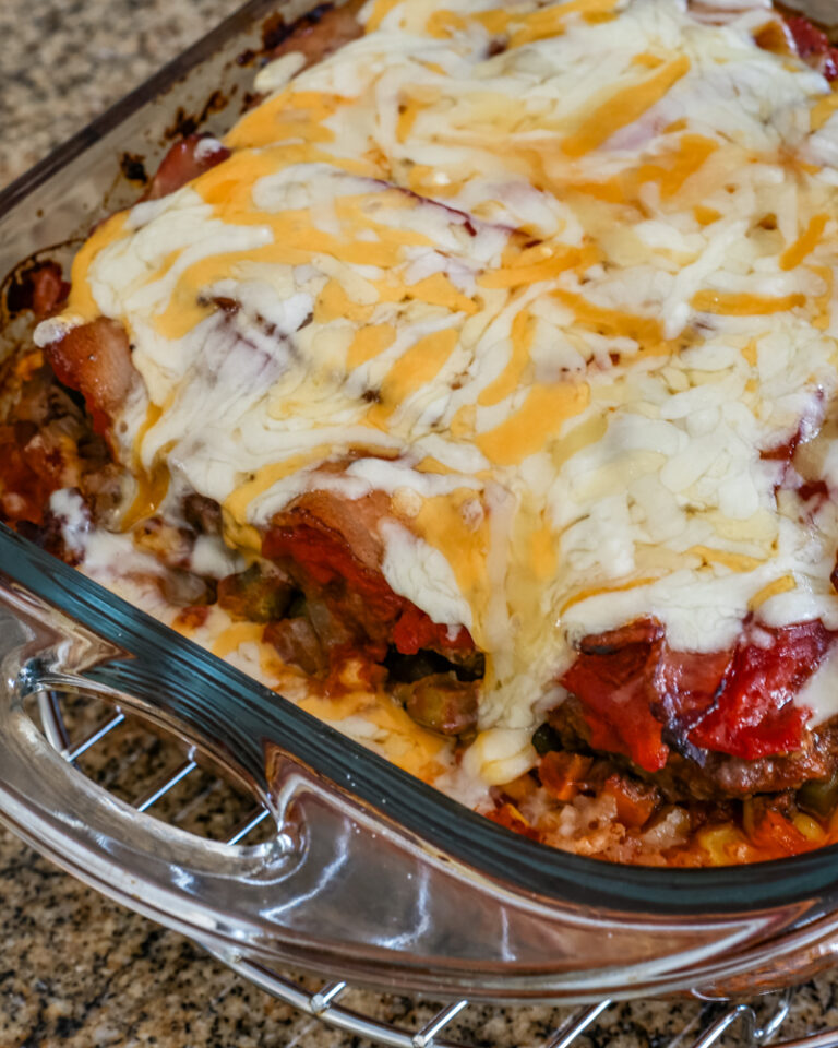 seven layer ground beef casserole with melted cheese on top