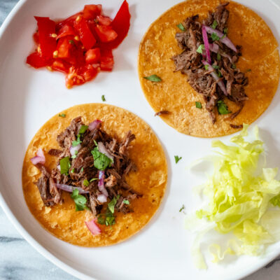 slow cooker barbacoa shredded on tortillas