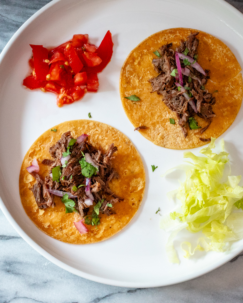 slow cooker barbacoa shredded on tortillas