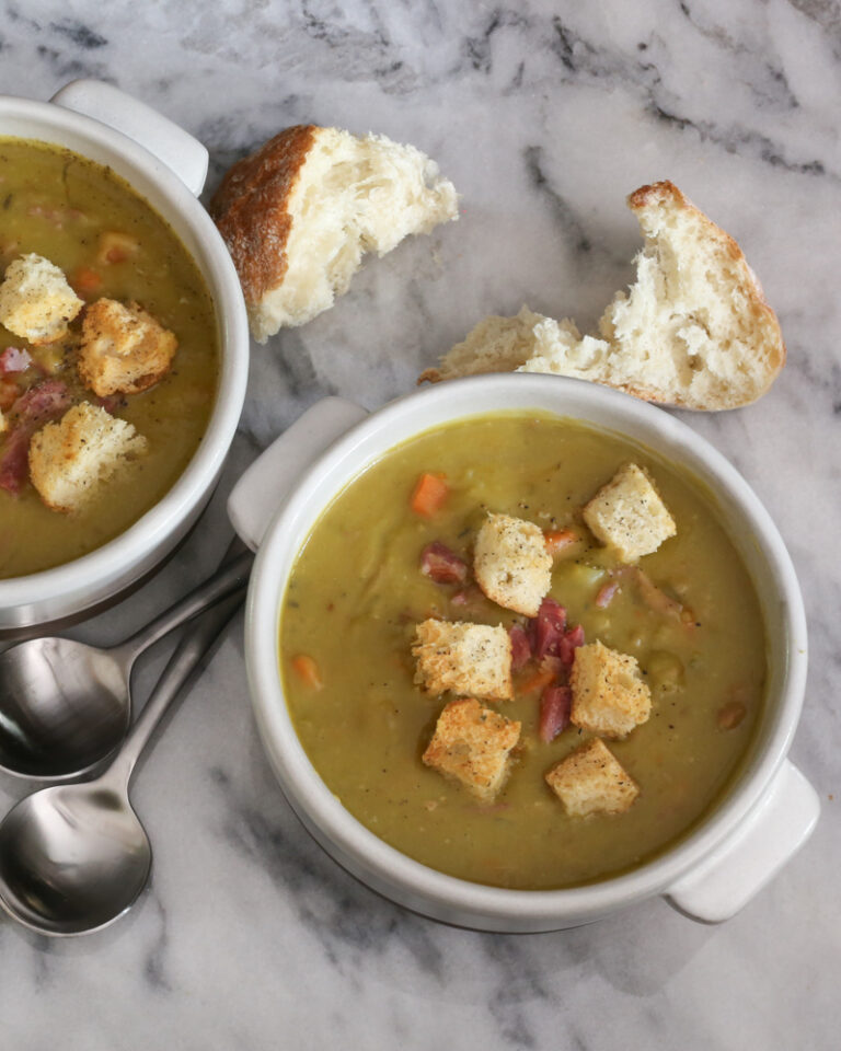 bowls of split pea soup and croutons