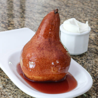 slow cooker wine poached pear on a serving dish