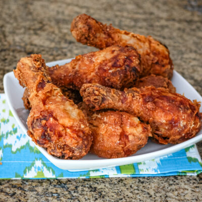 Fried chicken drumsticks in a serving dish