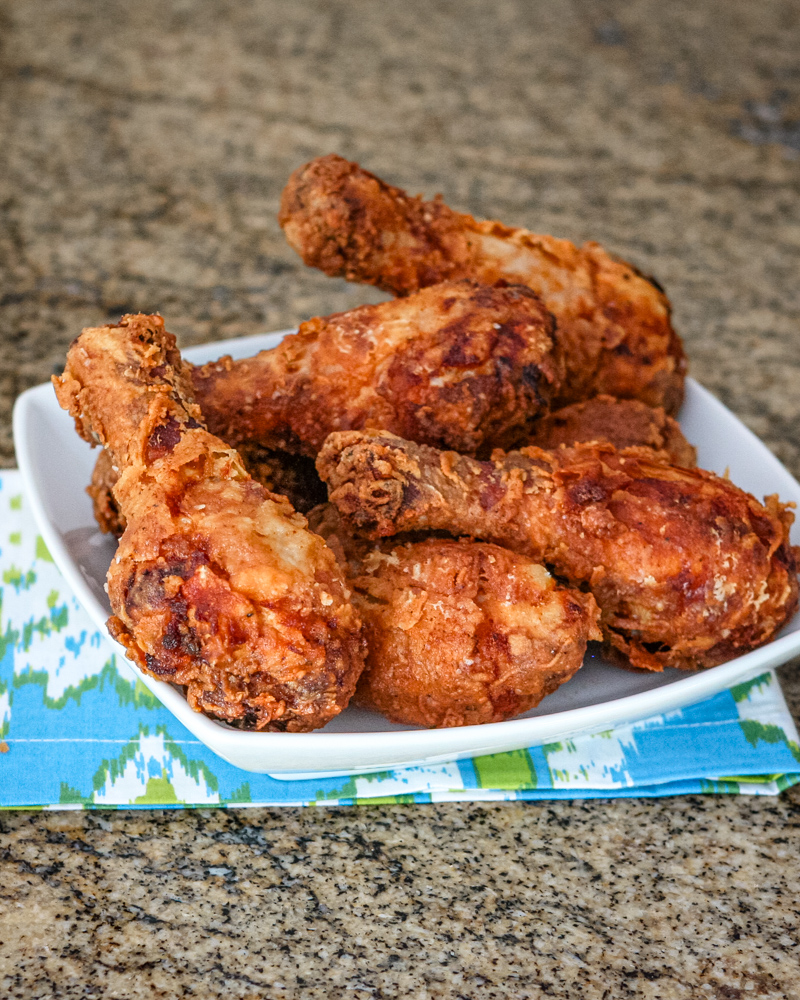 Fried chicken drumsticks in a serving dish