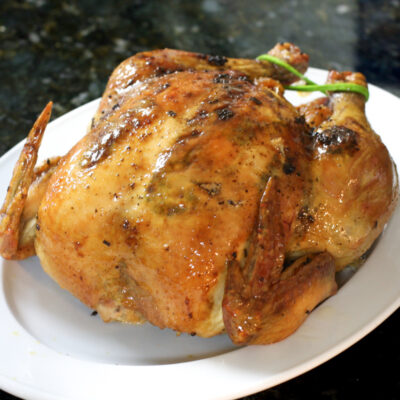 a sriracha glazed roast chicken on a platter