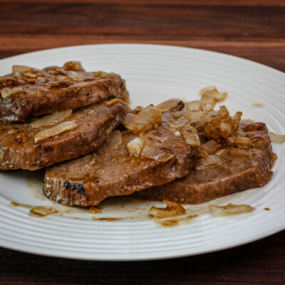 Marinated steak and onions on a plate