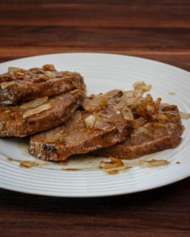Marinated steak and onions on a plate