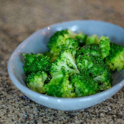 steamed broccoli in a small dish.