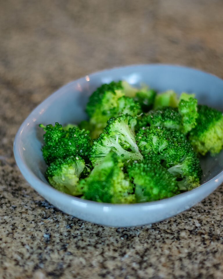 steamed broccoli in a small dish.