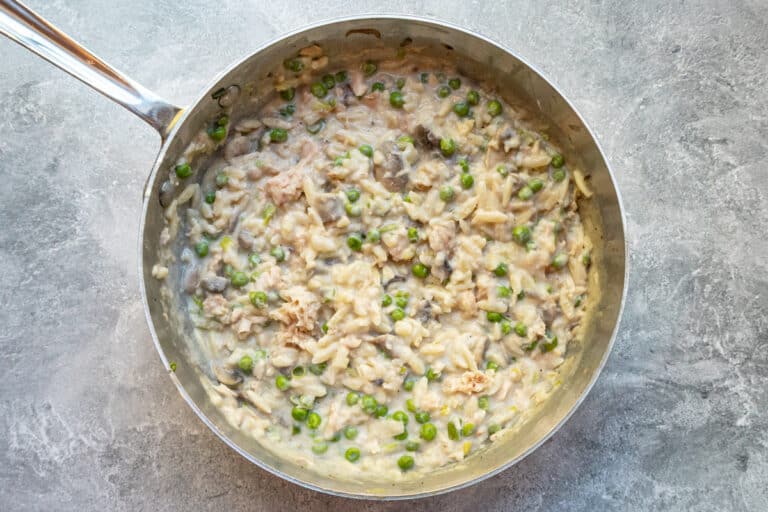 Tuna and orzo casserole filling mixture with peas and mushrooms.