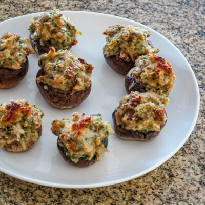 Easy stuffed mushrooms with clams in the bread stuffing mix, along with bacon, Parmesan cheese, and minced vegetables.