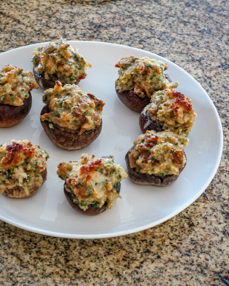 Easy stuffed mushrooms with clams in the bread stuffing mix, along with bacon, Parmesan cheese, and minced vegetables.