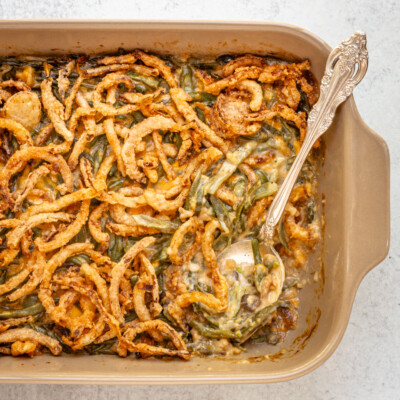 A baking dish with green bean casserole topped with crispy fried onions.