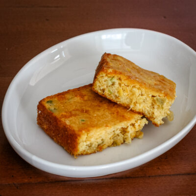 2 slices o Mexican cornbread in a dish.