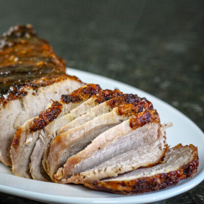 Mustard glazed pork loin on a platter.