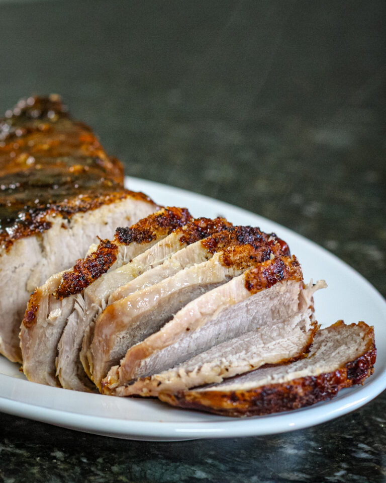 Mustard glazed pork loin on a platter.