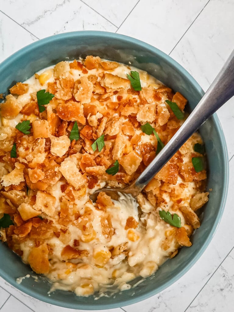 A bowl of scalloped corn with crumb topping.