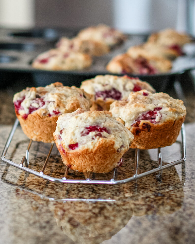 Raspberry muffins on a cooling rack.
