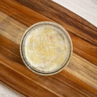 Shirred eggs baked in a glass ramekin with cheese topping.