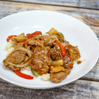sweet and sour pork tenderloin medallions on a serving plate.