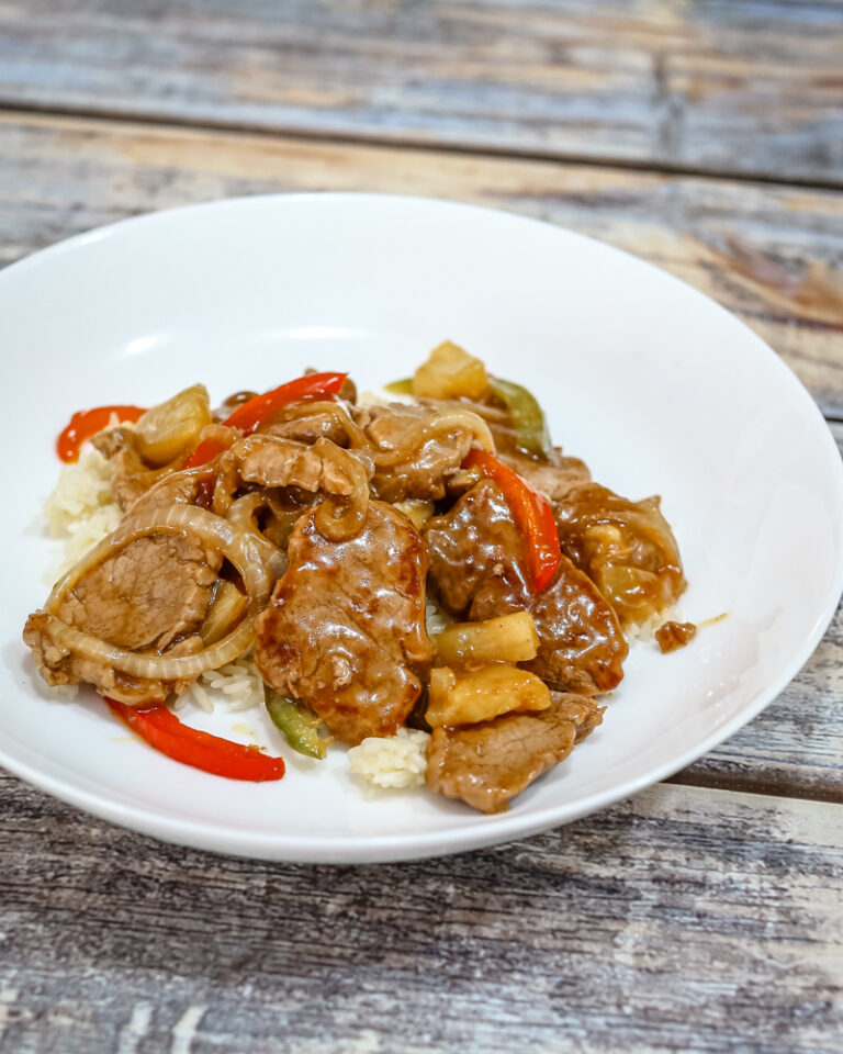 sweet and sour pork tenderloin medallions on a serving plate.