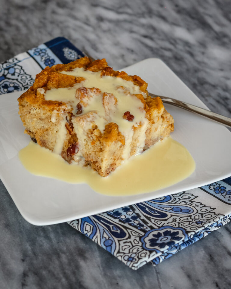 A slice of sweet potato bread pudding with vanilla sauce