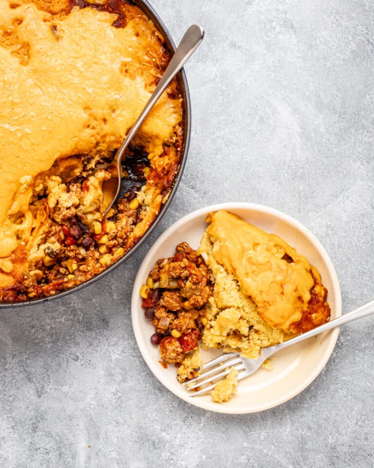 Overhead shot of a tamale pie with cheese topping and ground beef filling.