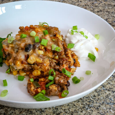 A layered Tex Mex style casserole, served with cilantro.