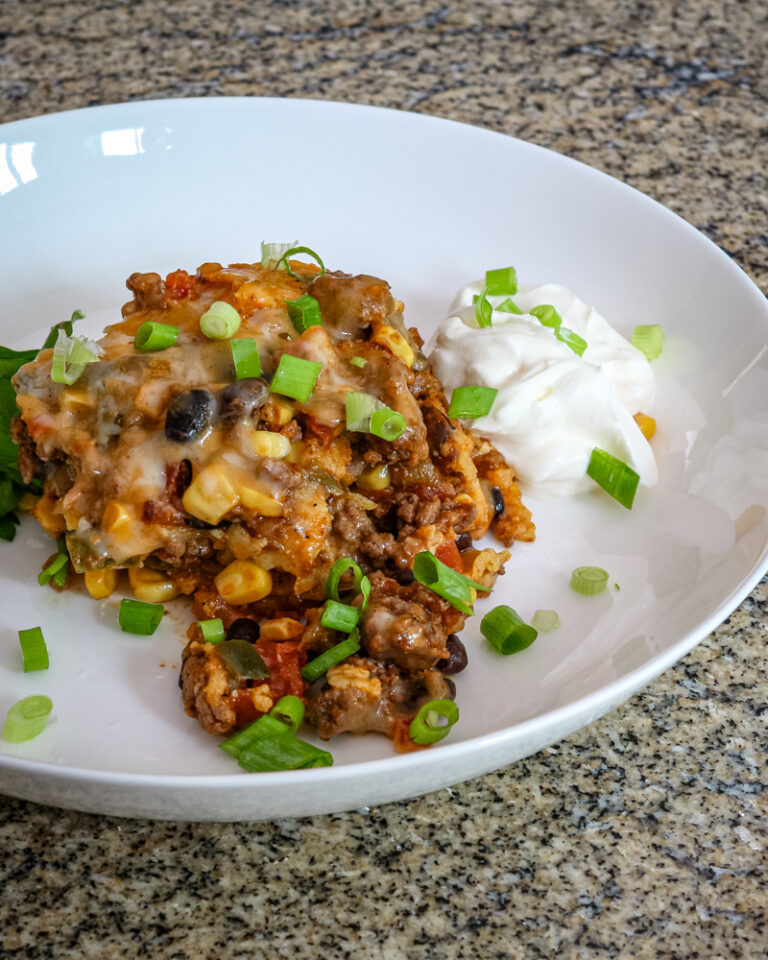 A layered Tex Mex style casserole, served with cilantro.