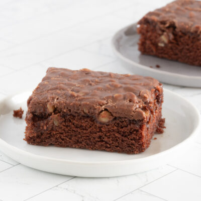 Sliced Texas sheet cake on plates.