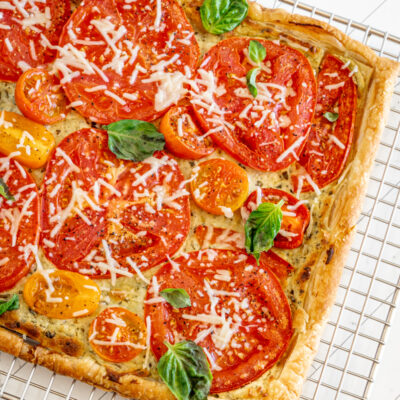 A freshly baked tomato tart with basil and Parmesan cheese.
