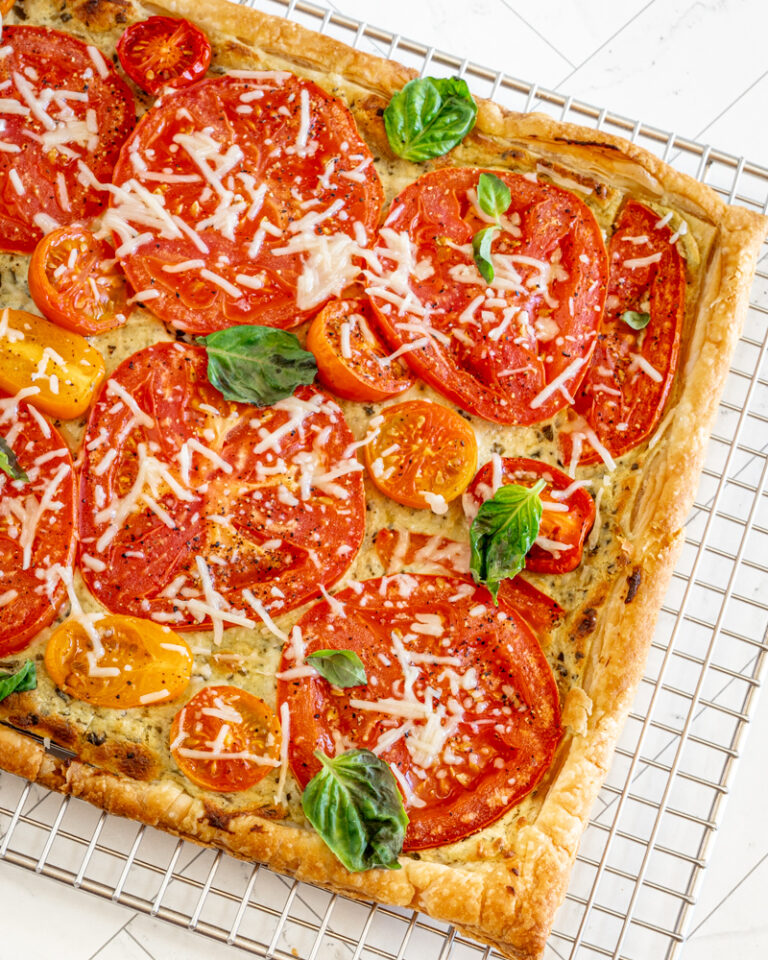 A freshly baked tomato tart with basil and Parmesan cheese.