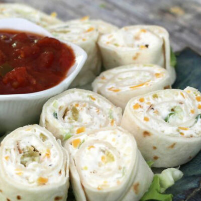 Tortilla roll-ups with salsa for serving