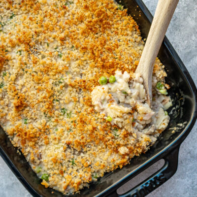 A baking dish with tuna casserole topped with buttered breadcrumbs.