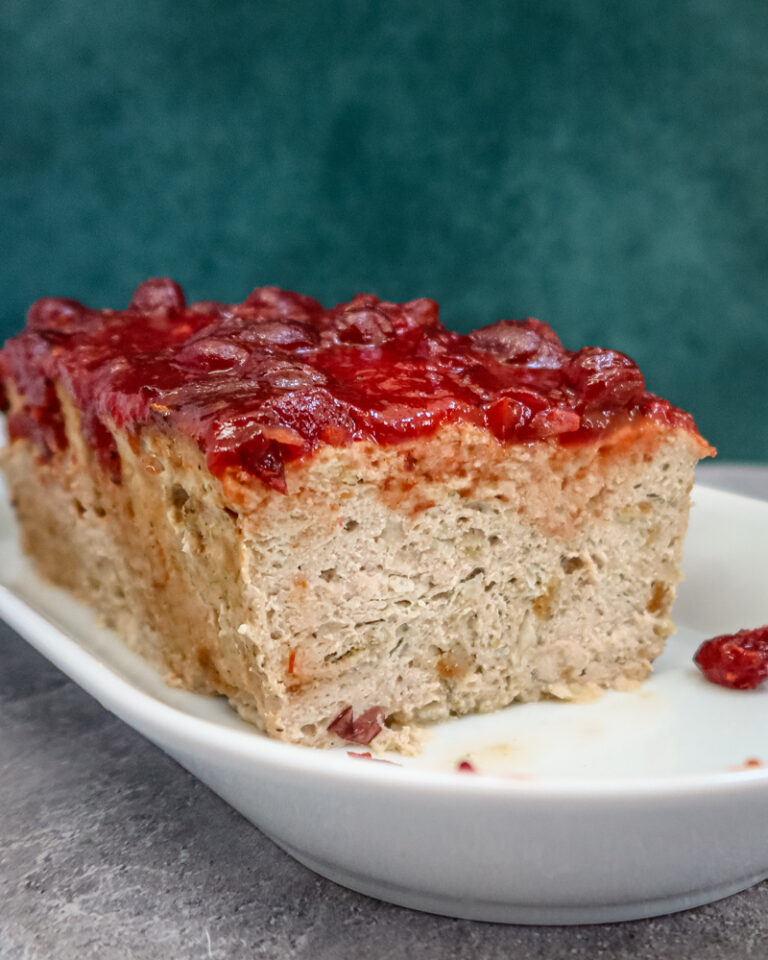 A sliced turkey meatloaf on a plate.
