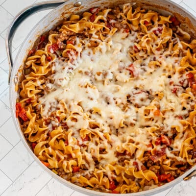 A beef and noodle skillet with melted cheese topping.