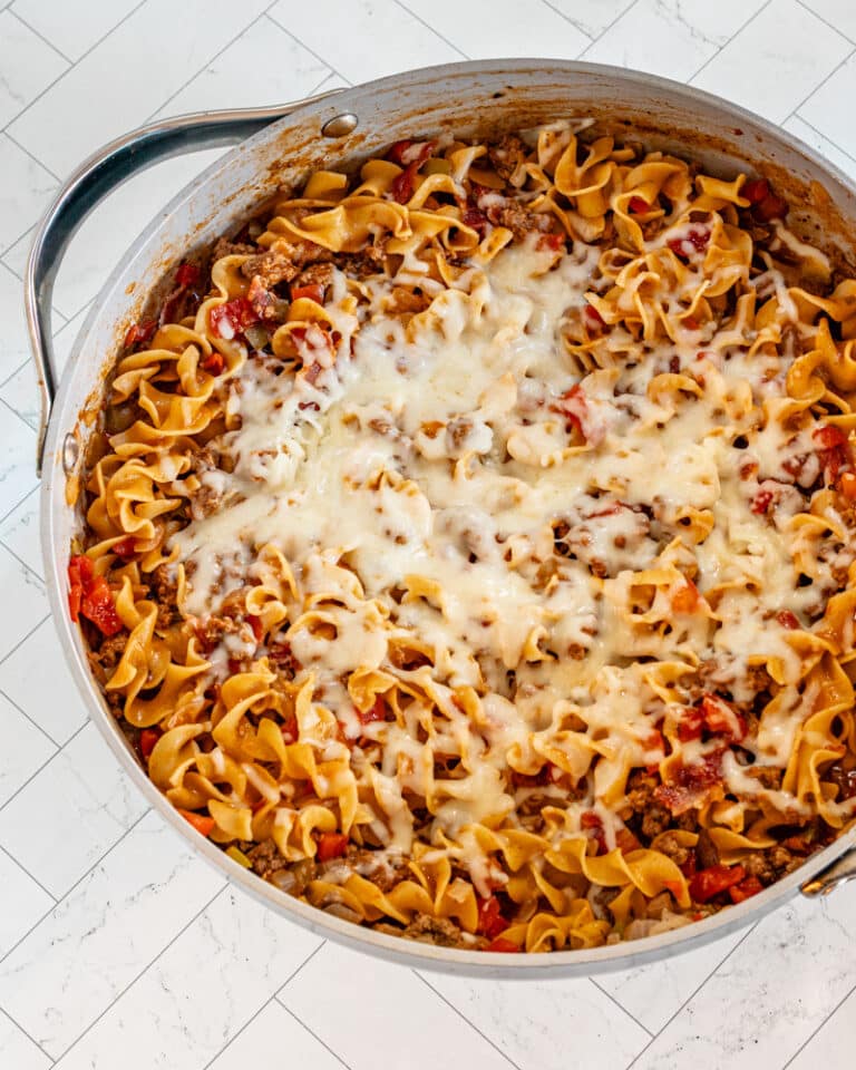 A beef and noodle skillet with melted cheese topping.