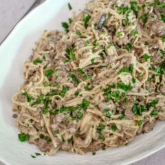 B.eef stroganoff with noodles in a serving dish