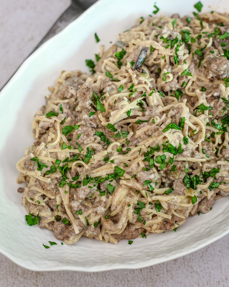 B.eef stroganoff with noodles in a serving dish