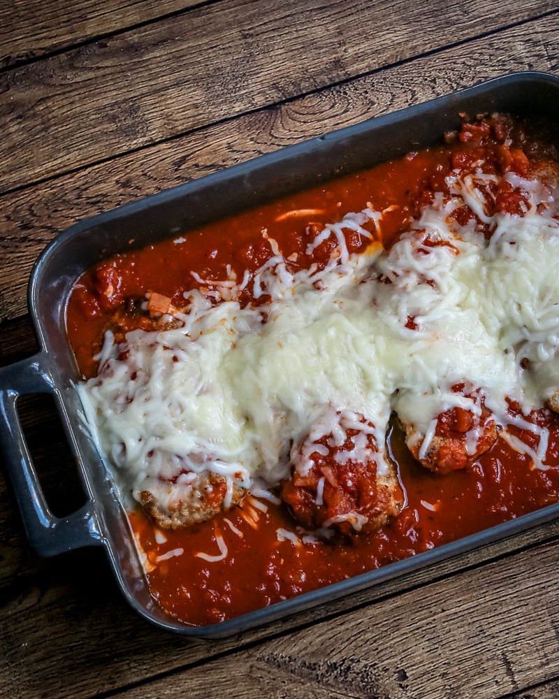 chicken parmigiana in a baking dish