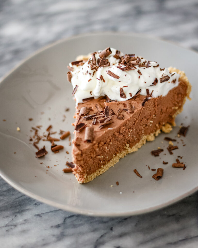 A chocolate amaretto pie garnished with whipped cream and chocolate