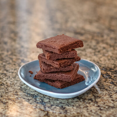 Chocolate shortbread stacked on a small plate
