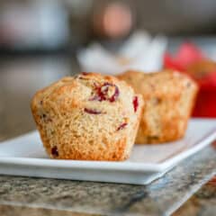A plate of freshly baked cranberry orange muffins.
