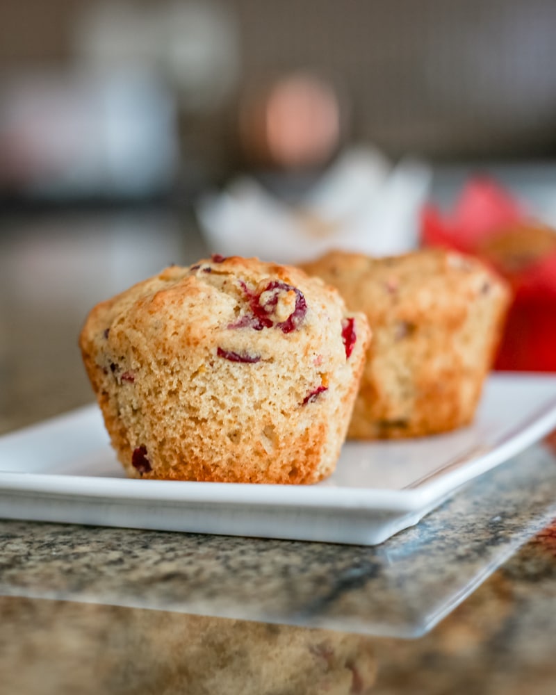A plate of freshly baked cranberry orange muffins.